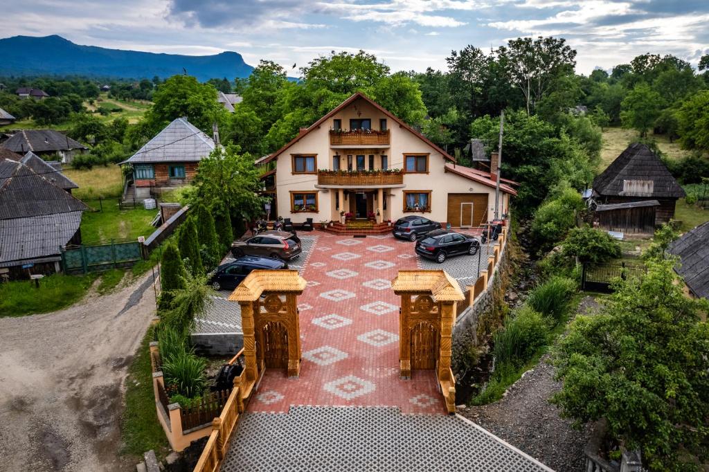 an aerial view of a house with cars parked in a driveway at Pensiunea Marioara in Breb