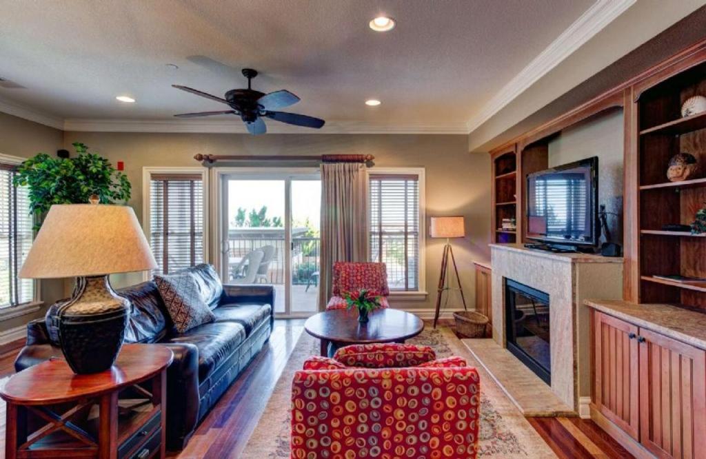 a living room with a couch and a fireplace at CSC2R - Dolphins Den in Kill Devil Hills