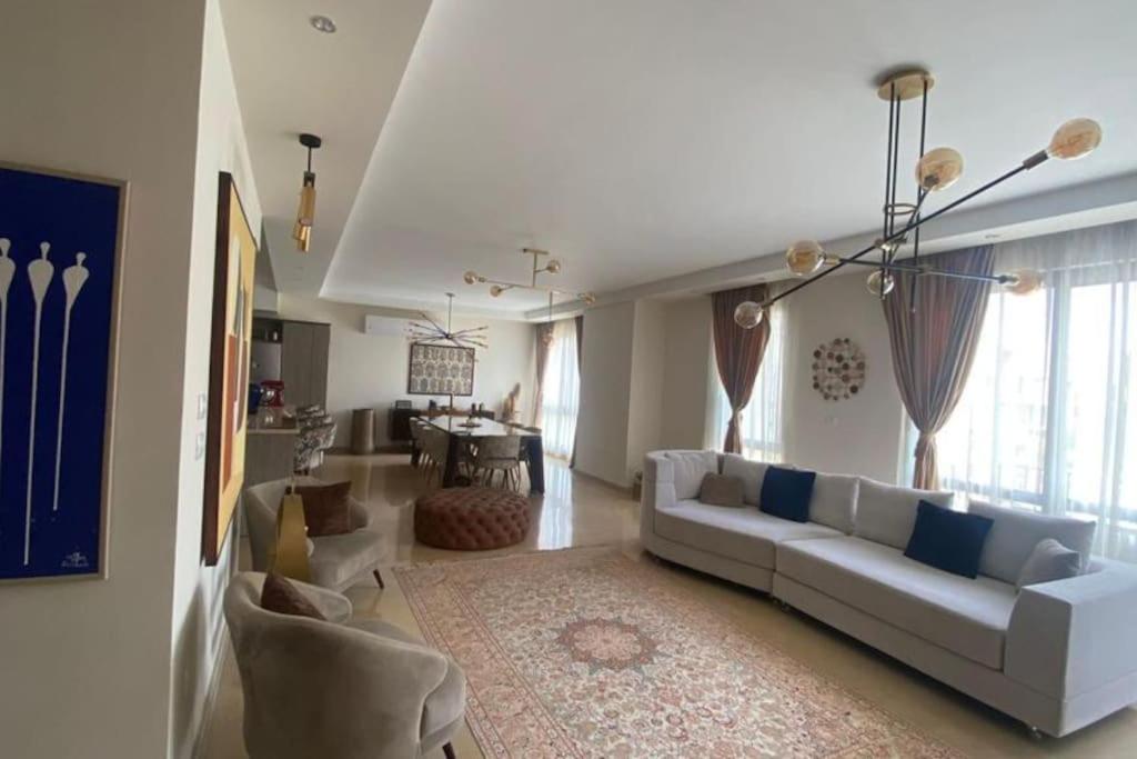 a living room with a white couch and a table at luxurious 2bed's duplex sheikh zayed beverly hills in Sheikh Zayed