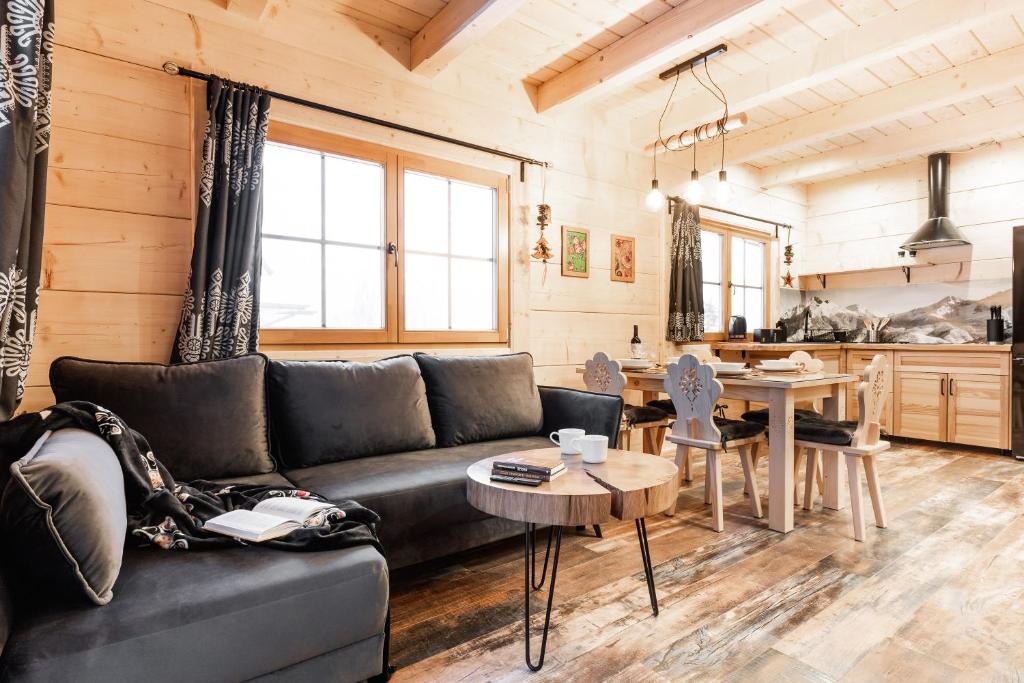 a living room with a couch and a table at Wierch Głodowski 25A Domek Bukowina in Bukowina Tatrzańska