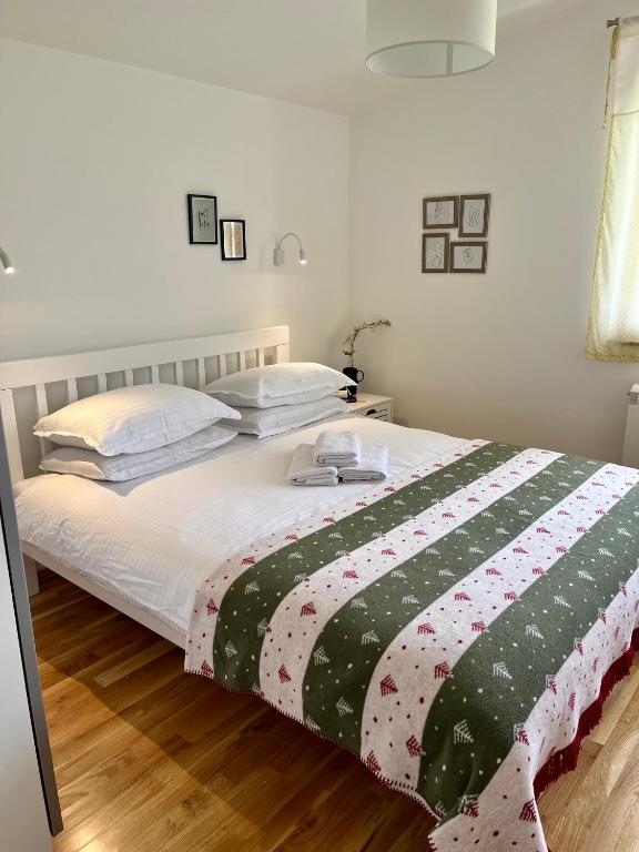 a bedroom with a bed with a black and white blanket at Divine House in Žabljak