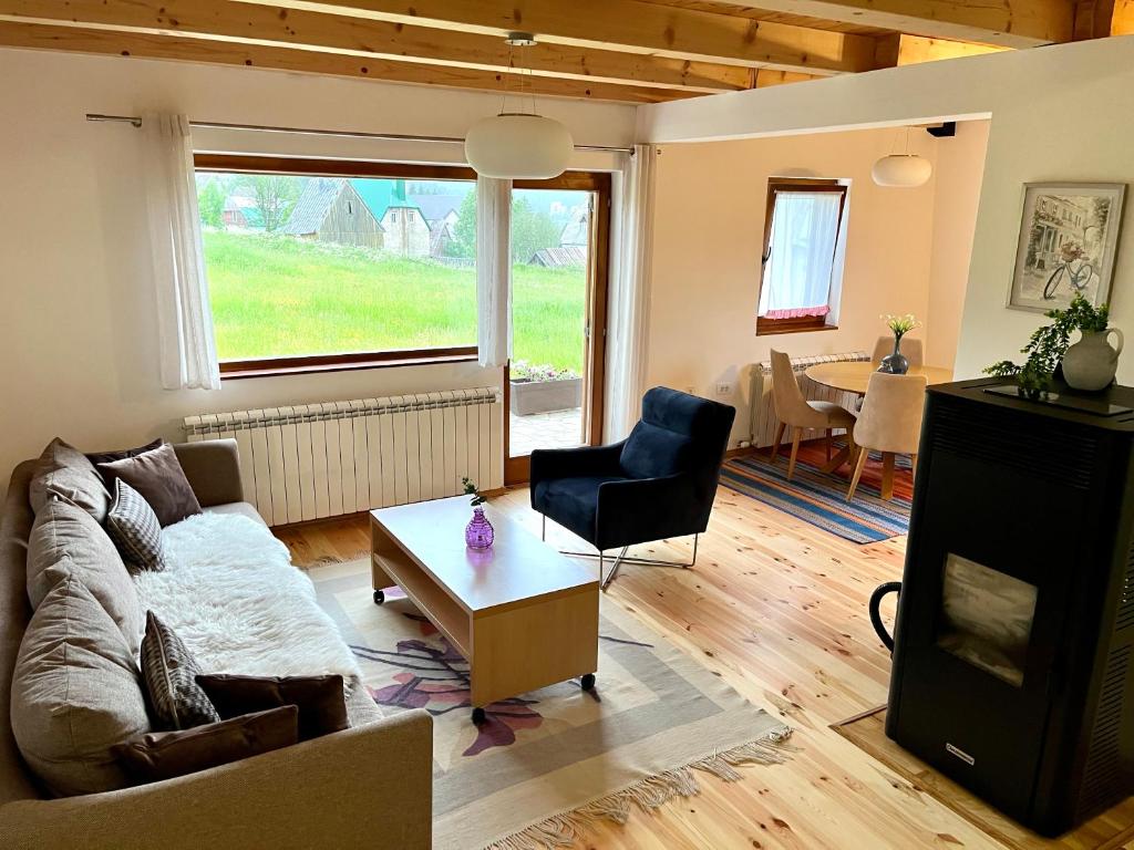 a living room with a couch and a table at Divine House in Žabljak