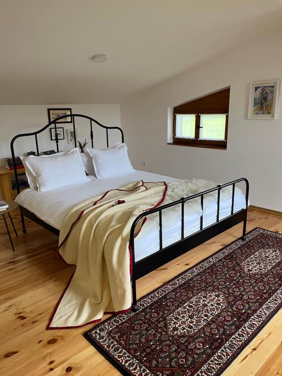 a large bed in a room with a rug at Divine House in Žabljak