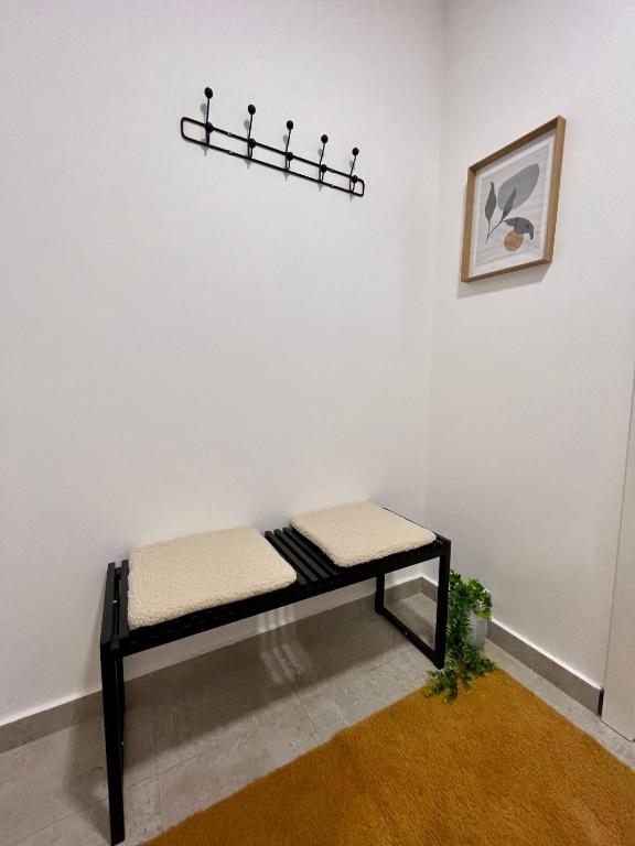 a bench in a room with a white wall at Divine House in Žabljak