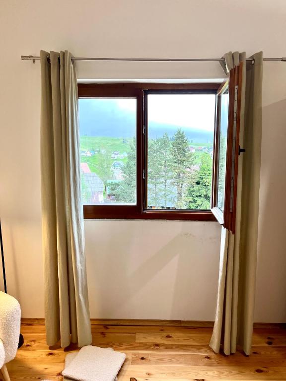 a room with a window with a view at Divine House in Žabljak