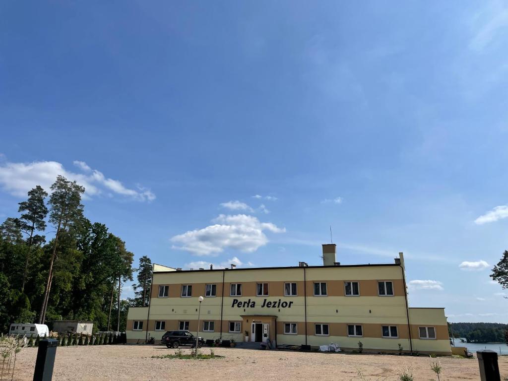 a large building with the words fight leader on it at Perła Jezior in Ruciane-Nida