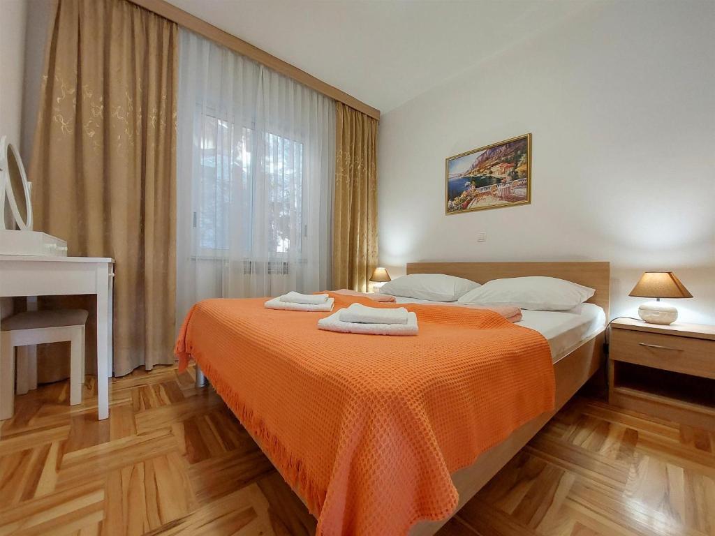 Postel nebo postele na pokoji v ubytování Apartments Zeljko