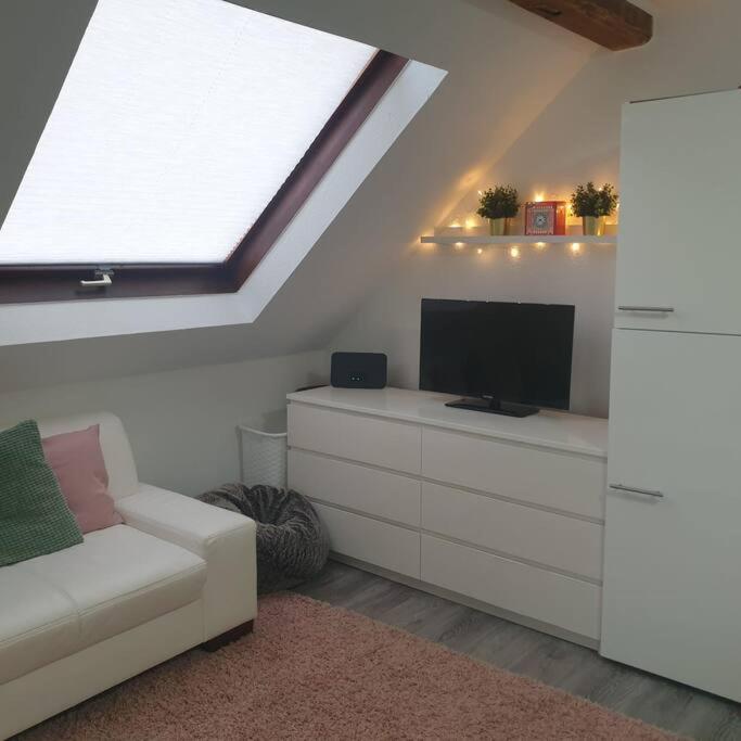 a living room with a couch and a flat screen tv at Obere Dorfstraße in Wolfsburg
