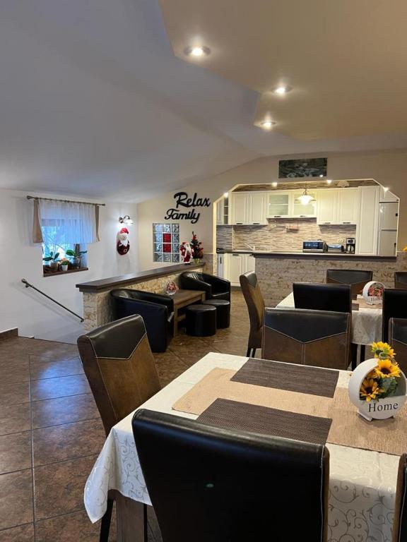 a restaurant with tables and chairs and a bar at Apartament Darius in Moieciu de Sus