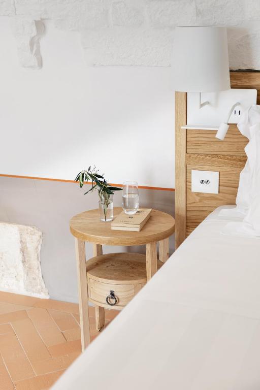 a bed room with a small table next to a bed at Masseria Auraterrae in Polignano a Mare