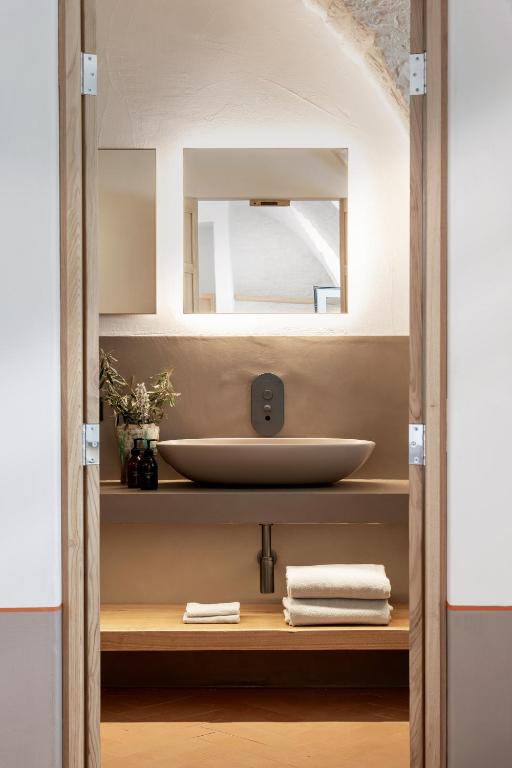 a bathroom with a sink and a mirror at Masseria Auraterrae in Polignano a Mare