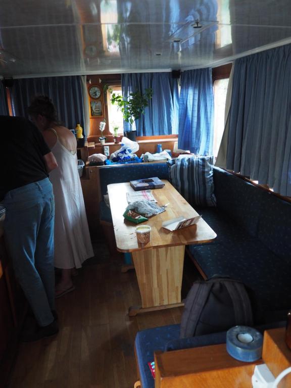 a group of people in a living room with a table at Peniche BROCOR hébergement avec participation a la navigation sur le Canal du Midi in Béziers