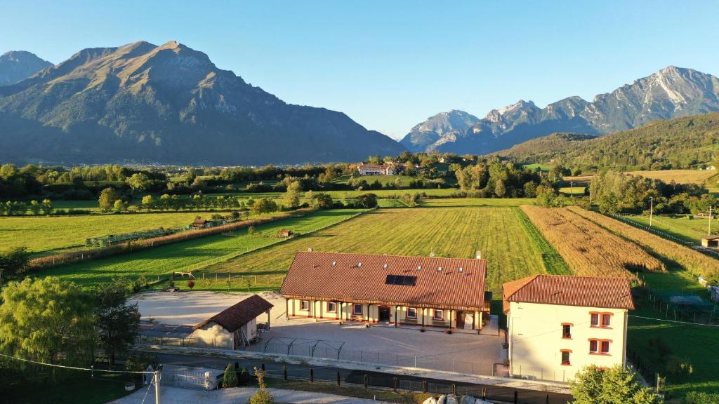 an aerial view of a farm with mountains in the background at AGRITURISMO MODOLO Belluno Dolomiti in Belluno