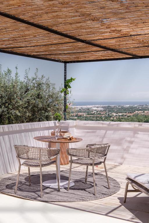 two chairs and a table on a patio at Masseria Auraterrae in Polignano a Mare