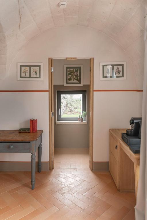 a kitchen with a table and a window at Masseria Auraterrae in Polignano a Mare