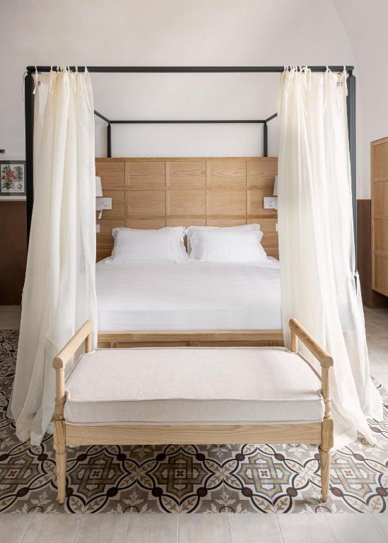 a bedroom with a bed with a wooden bed frame at Masseria Auraterrae in Polignano a Mare