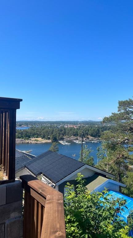 a view of a river from a balcony of a house at Moderne Leilighet med panorama utsikt check -In 24 h in Sandefjord
