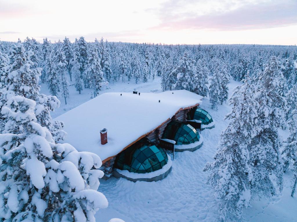 an aerial view of a snow covered forest with tents at Utsjoki Arctic Resort in Utsjoki