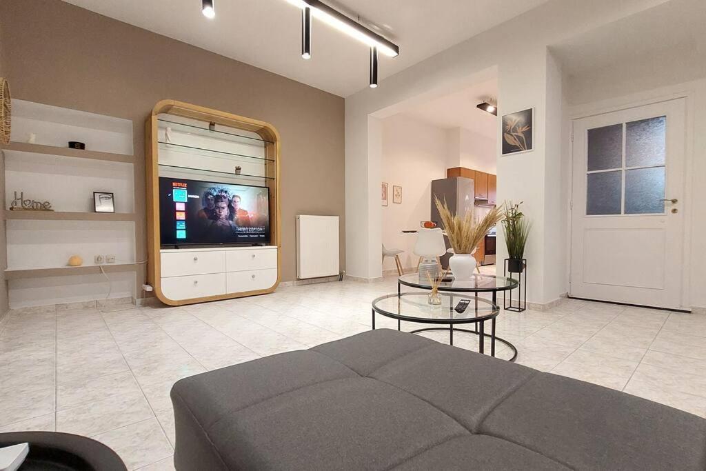a living room with a couch and a television at Avli House in Heraklio Town