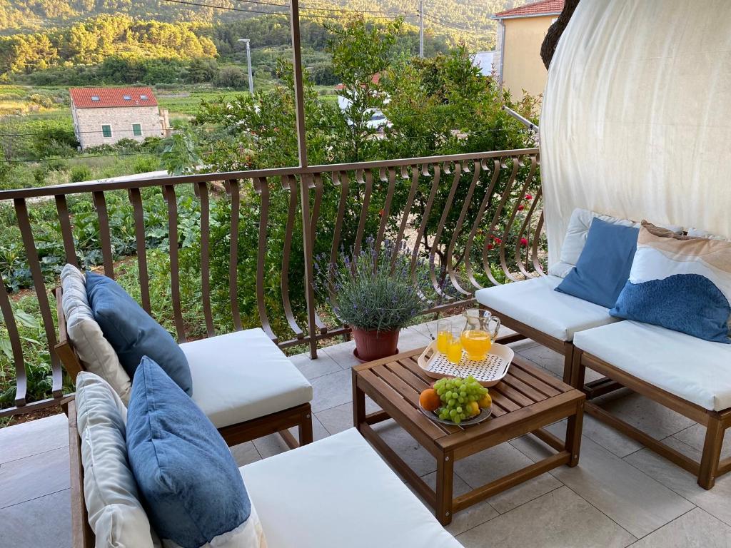 a patio with two chairs and a table with oranges on it at Holiday home Mandi in Vrbanj