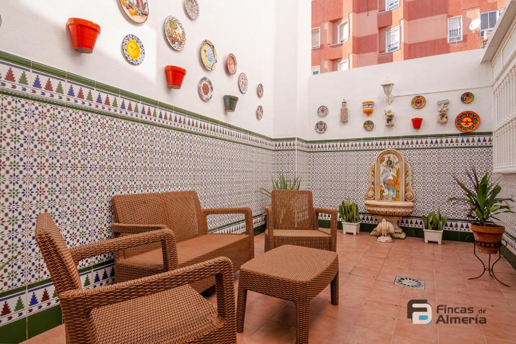 a waiting room with chairs and plates on the wall at Pedro Jover 9 R&R in Almería