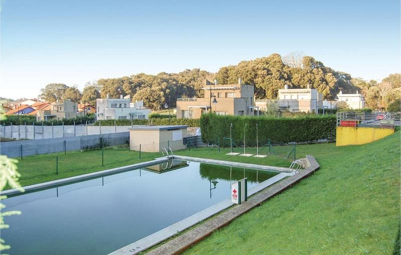 a large pool of water in a park with houses at Apartamento Boutique Arquera Golf II -Llanes in Llanes