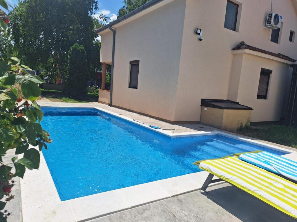 a swimming pool with a bench next to a house at House Reko in Novi Grad