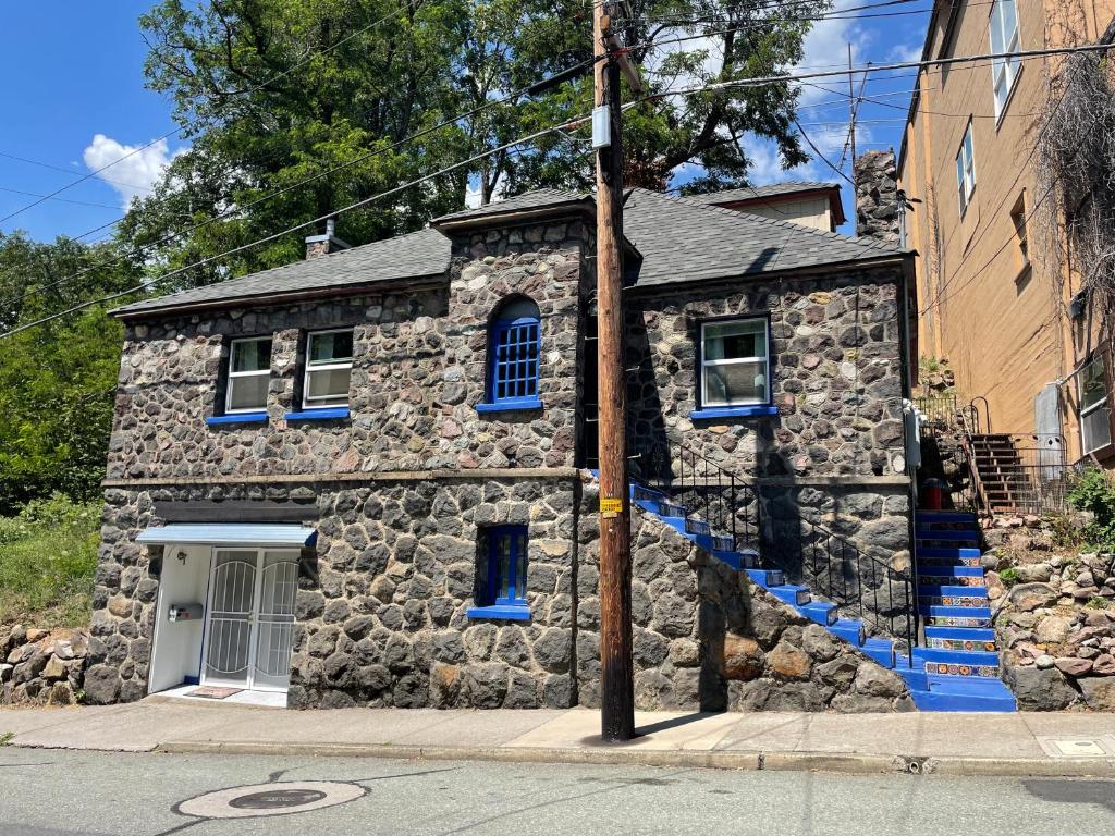 a stone house with blue stairs on a street at Come and Get your Love at Hikers Haven! Only 10 minutes from Mount Shasta-Pet Friendly in Mount Shasta