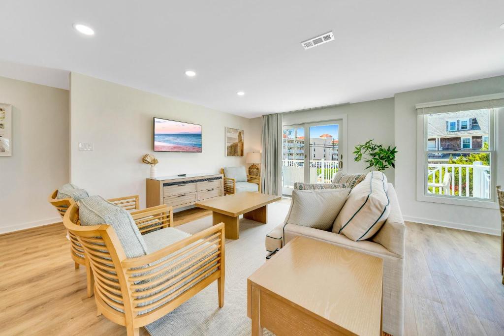 a living room with a couch and chairs at Mahalo Cape May Townhomes in Cape May
