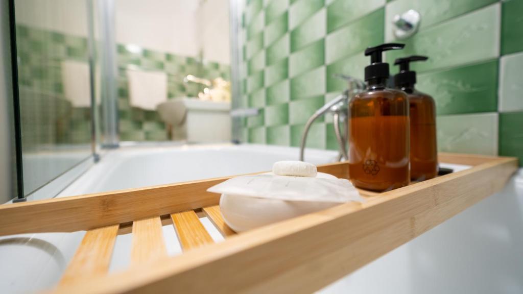 a bathroom with a bath tub with a soap dispenser at Apartmani Gruzdovo in Delnice