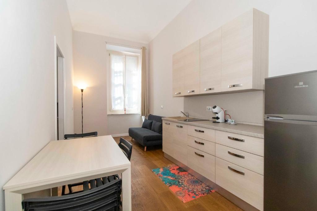 a kitchen with a refrigerator and a table in it at Piccolo Principe in Turin