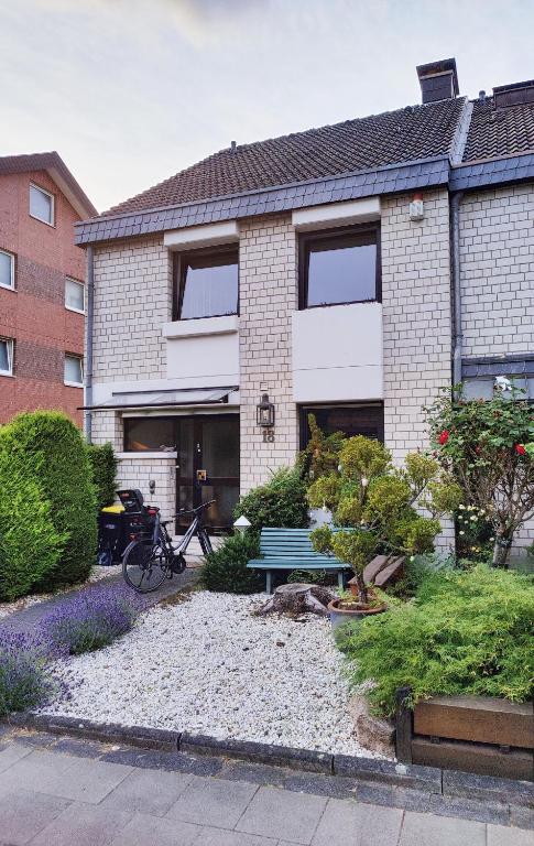 a house with a bench in front of it at Spacious & comfortable guestrooms w private bathrooms near Koelnmesse & Lanxess Arena, free parking, highspeed WiFi in Cologne