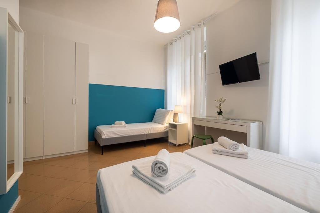 a hotel room with two beds and a couch at Mia Rooms - Room with Private Bath Bolzano Center01 in Bolzano