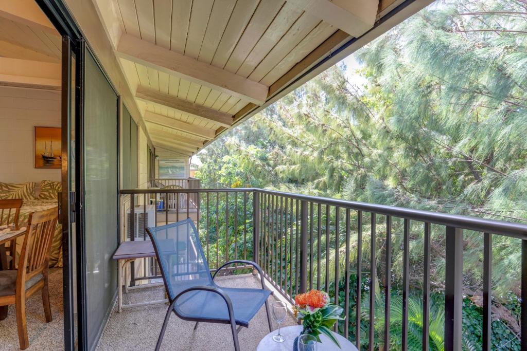 a balcony with two chairs and a table at Hono Kai C10 in Maalaea