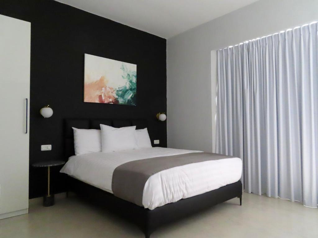 a bedroom with a large bed with a black headboard at White Moon Inn in Jerusalem