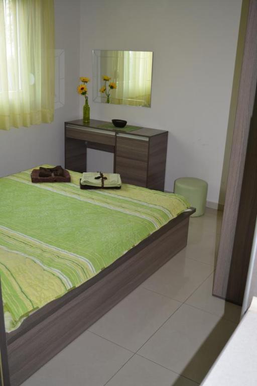 a bedroom with a bed with a dresser and a mirror at Beauty Apartment in Ohrid