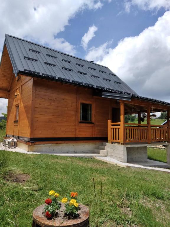 a large wooden house with a solar roof at Brvnara Srna Zlatar in Nova Varoš