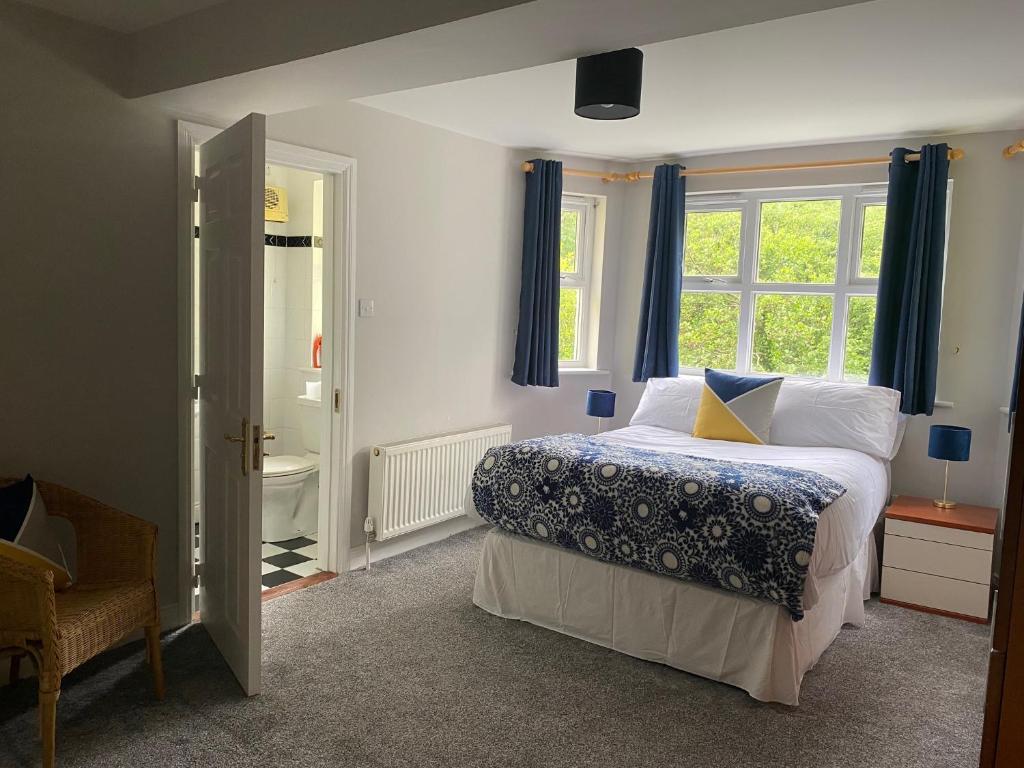 a bedroom with a bed and a window at No 3 Aughrim Holiday Village in Aughrim