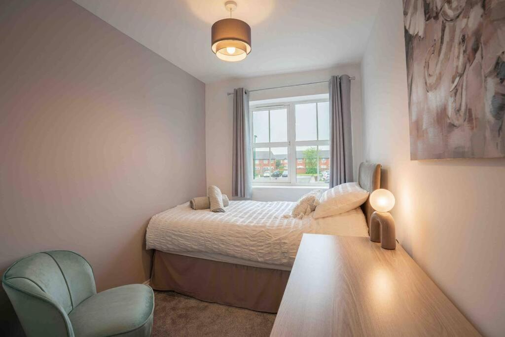 a small bedroom with a bed and a window at Long-term stay for HS2 contractors & families in Marston Green