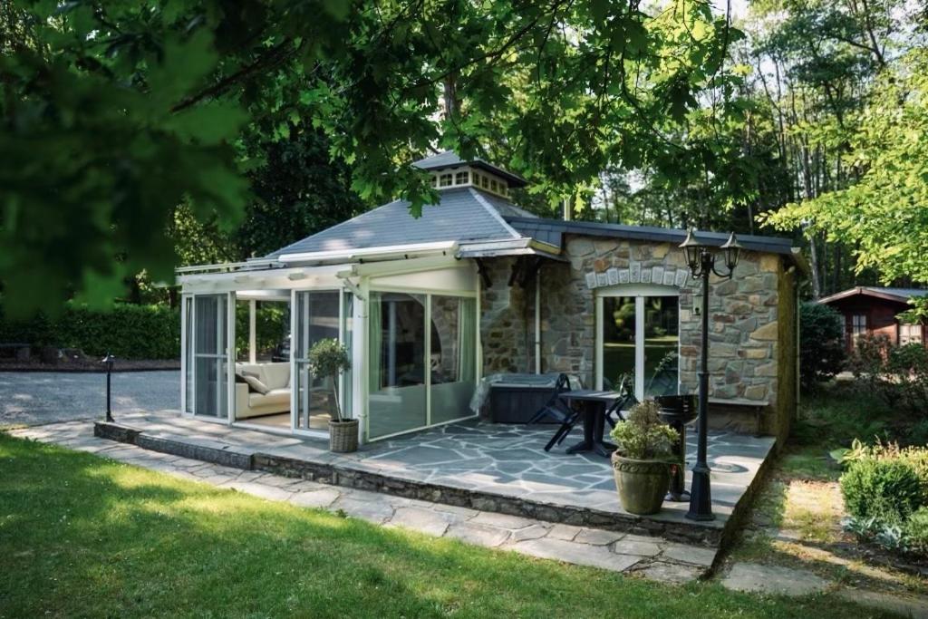 a gazebo with a patio in a yard at La Source Marie-Elise in Stavelot