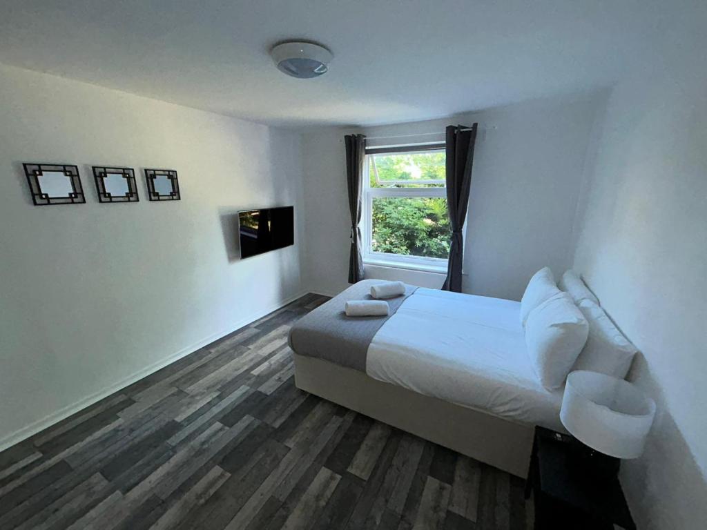 a hotel room with a bed and a window at St Pauls Court Apartments in Stockton-on-Tees