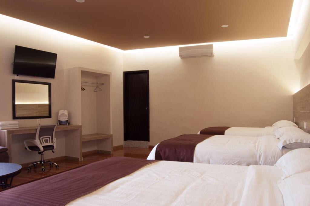 Postel nebo postele na pokoji v ubytování Hotel Luna Caribe