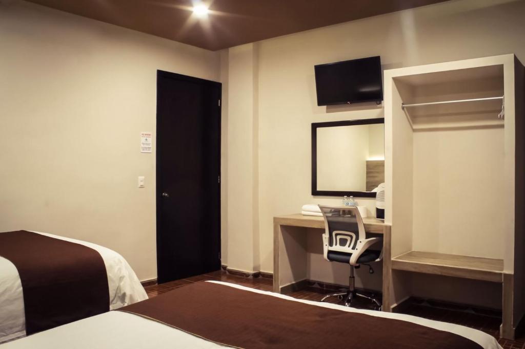 Postel nebo postele na pokoji v ubytování Hotel Luna Caribe
