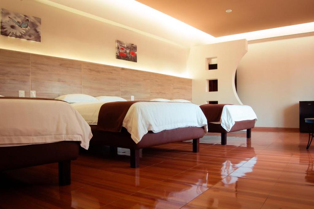 Postel nebo postele na pokoji v ubytování Hotel Luna Caribe