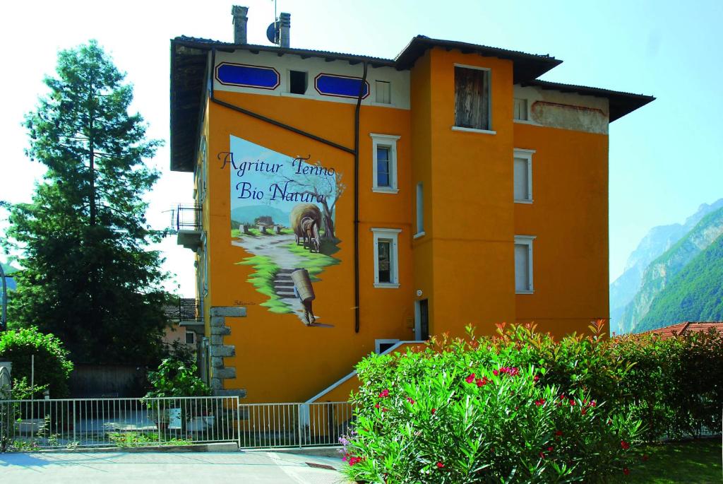 a building with a mural on the side of it at Agritur Tenno Bio Natura in Tenno