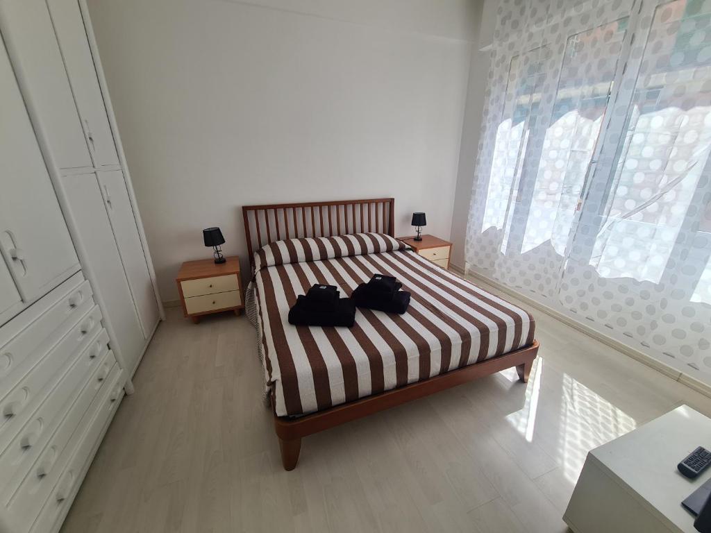 a bedroom with a bed with two bags on it at Casa Patrizia by PortofinoVacanze in Rapallo