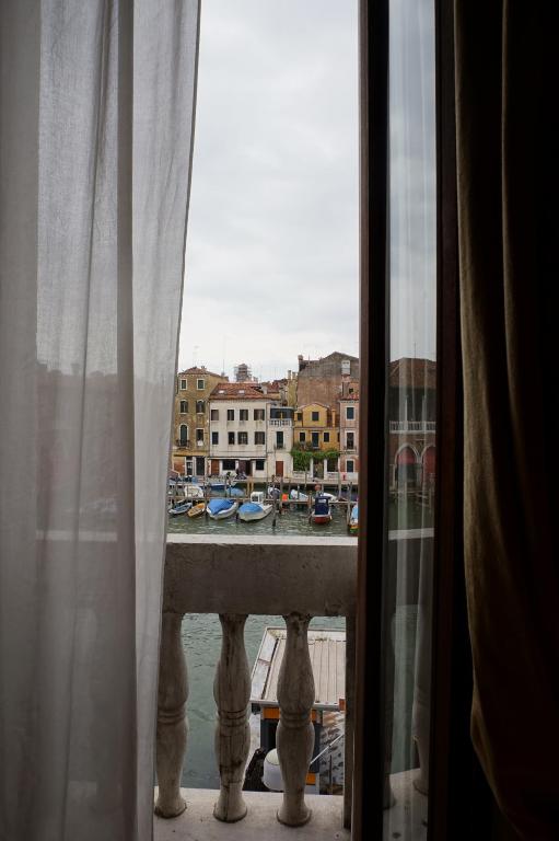 a view of a harbor from a window at Pesaro Palace in Venice