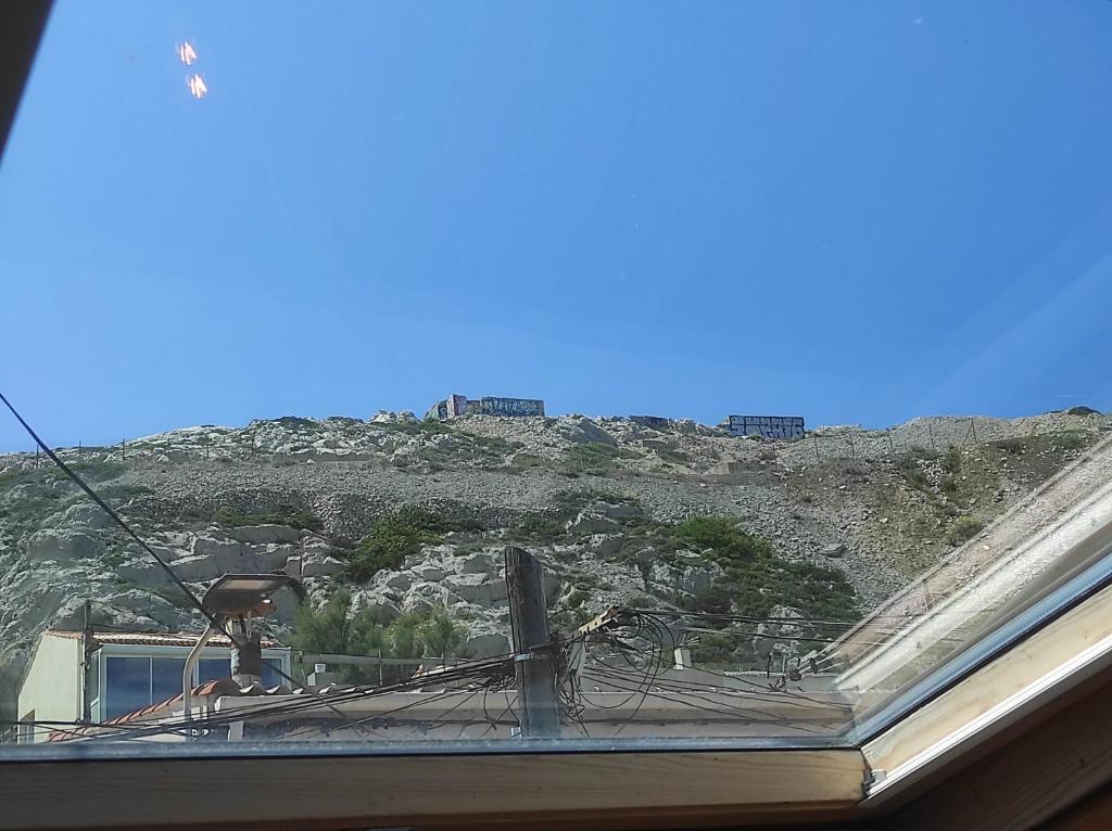 a view of a mountain from the roof of a house at Chill Out Cabanon Coeur Calanques in Marseille