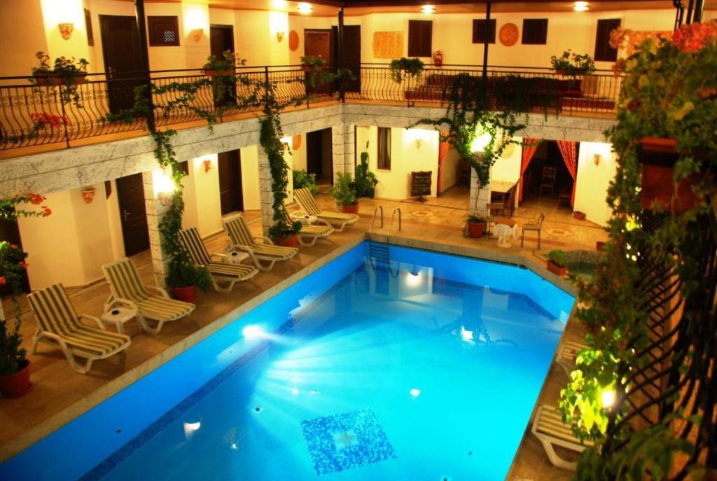 a large swimming pool in a building with chairs at Han Dalyan Hotel in Dalyan