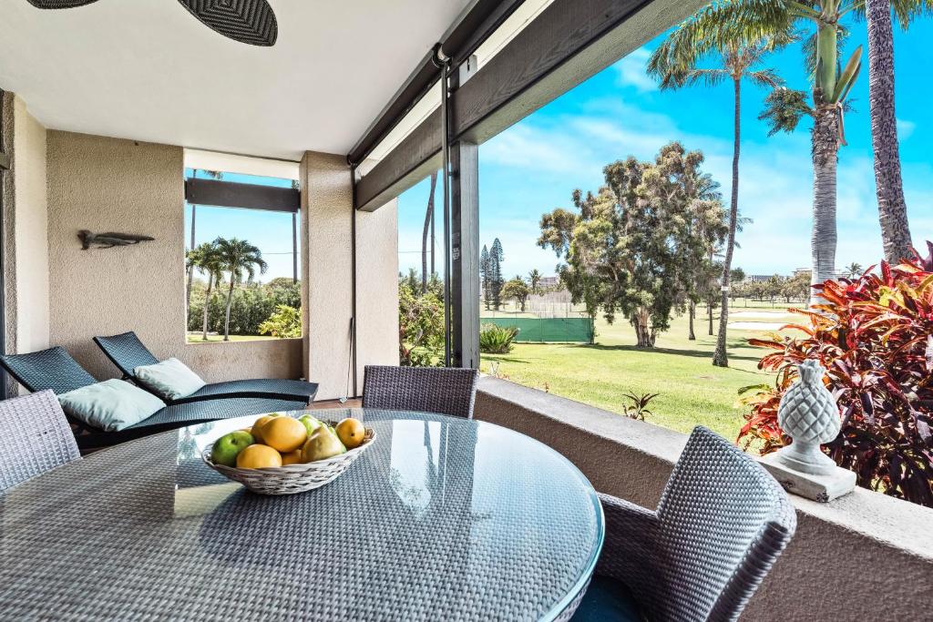 - une table en verre avec un bol de fruits sur la terrasse dans l'établissement Kaanapali Royal C101, à Lahaina